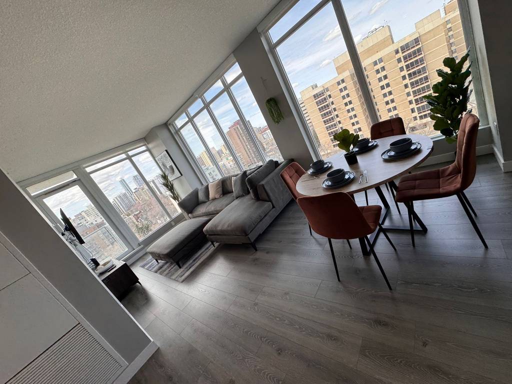 Exterior window cleaning on a multi-family residential home with large front-facing windows