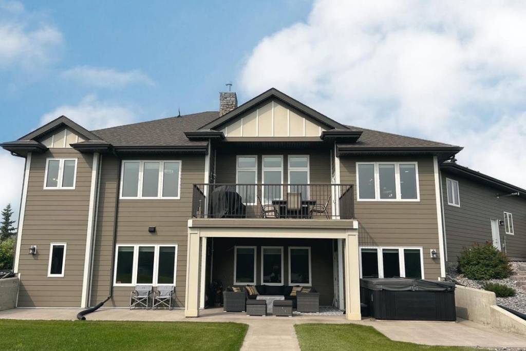 Exterior window cleaning on a multi-family residential home with large front-facing windows