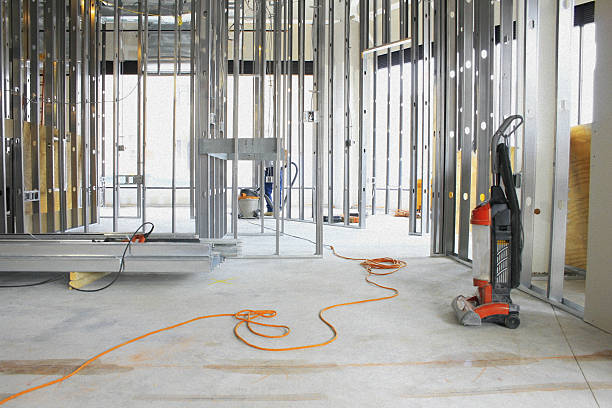 Vacuumed construction site with exposed framing and orange power cords